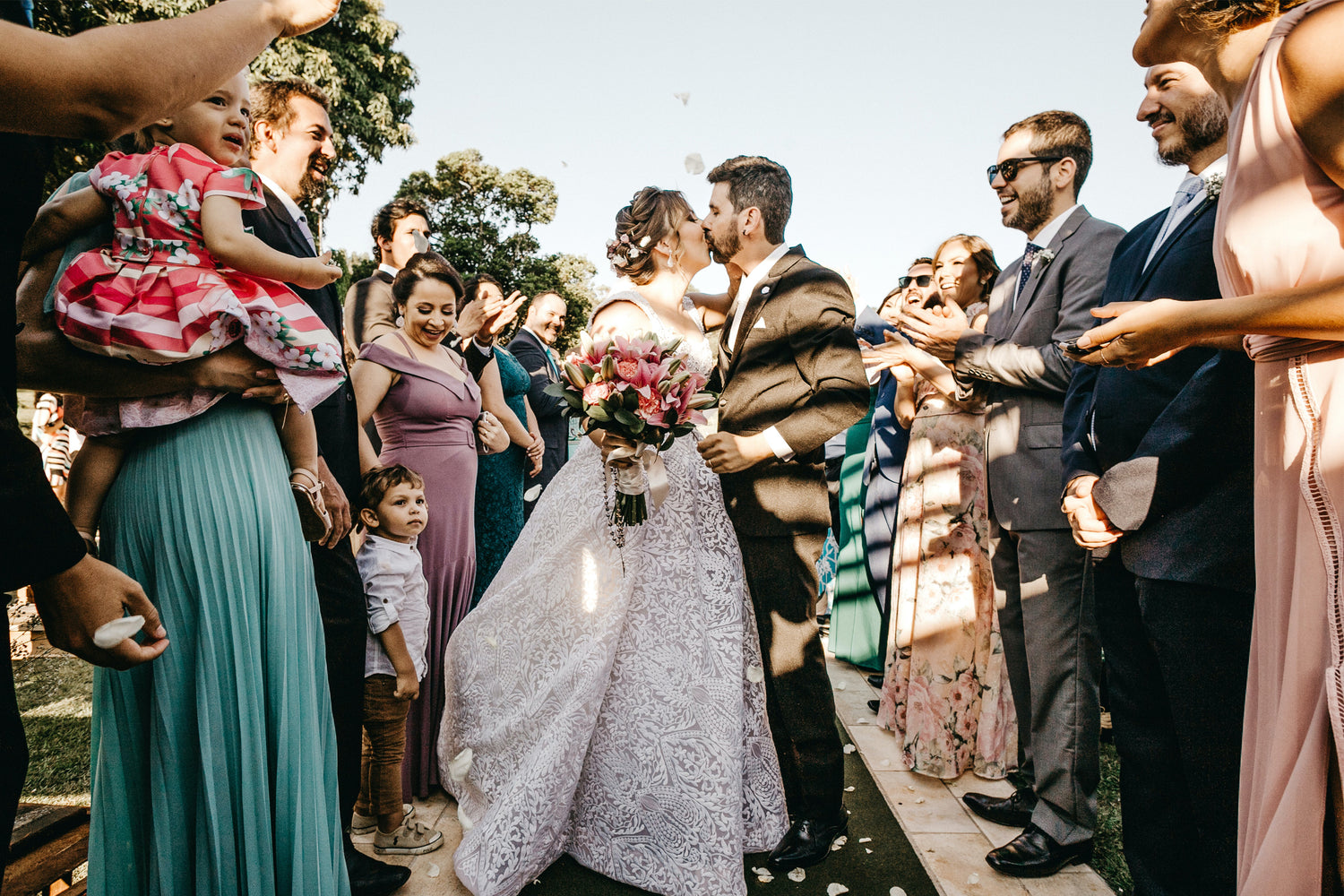 Newlyweds' First Kiss": An enchanting moment as the bride and groom share their first kiss as a married couple, surrounded by love and celebration at their wedding.